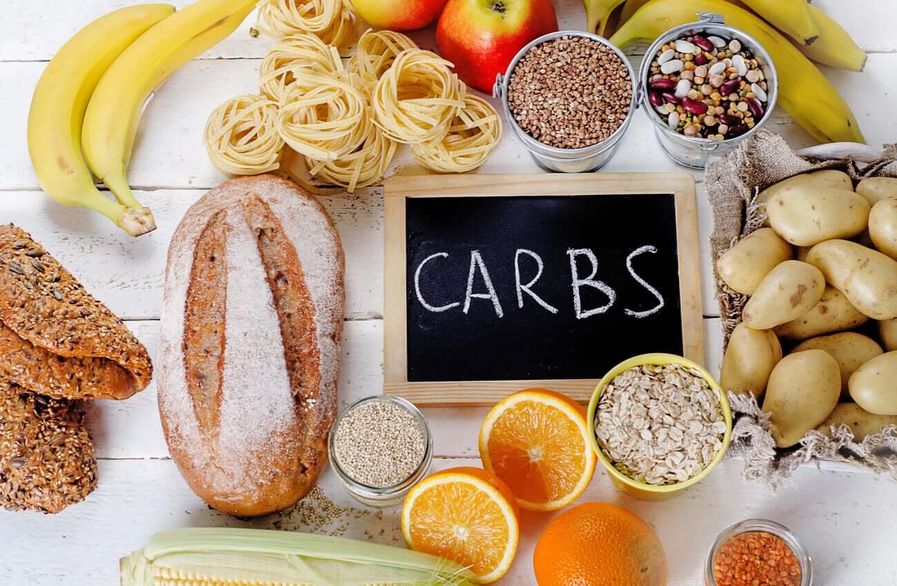 A variety of carbohydrate sources, including bread, pasta, fruit, and seeds.