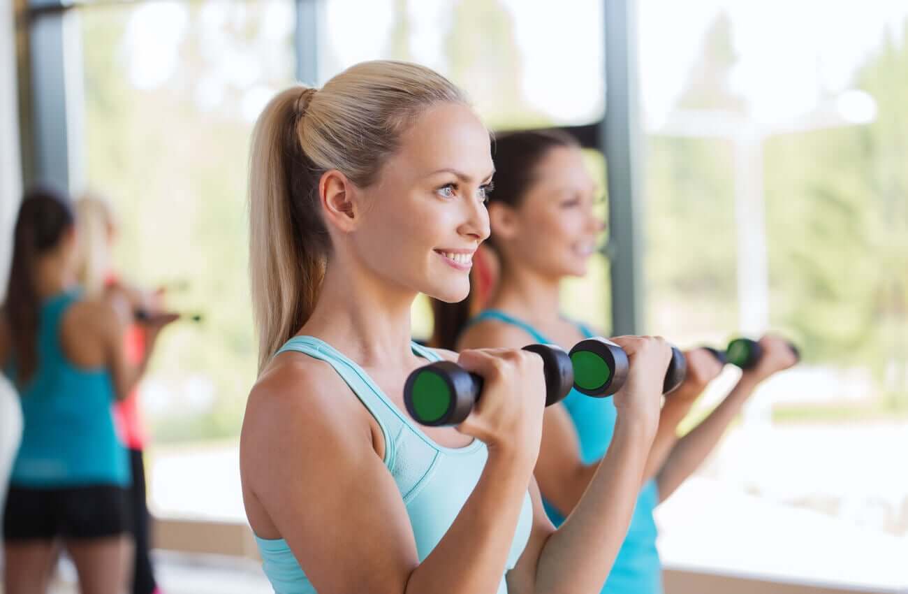 A few women doing biceps curls.