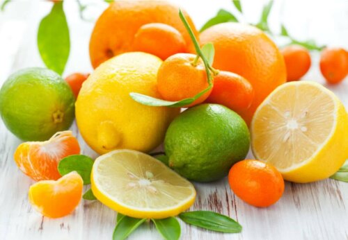 citrus fruits on a table; oranges, limes, lemons