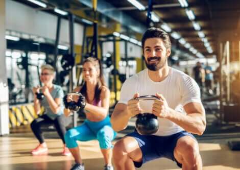 A group of people doing squats with weights.