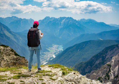 person standing on mountain after hiking