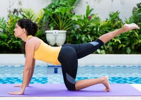 A woman doing hip extension exercises to strengthen her glutes.
