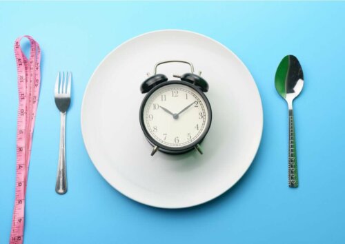 clock on plate with fork and spoon