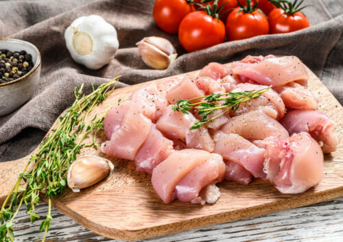 raw chicken on a platter with some seasonings