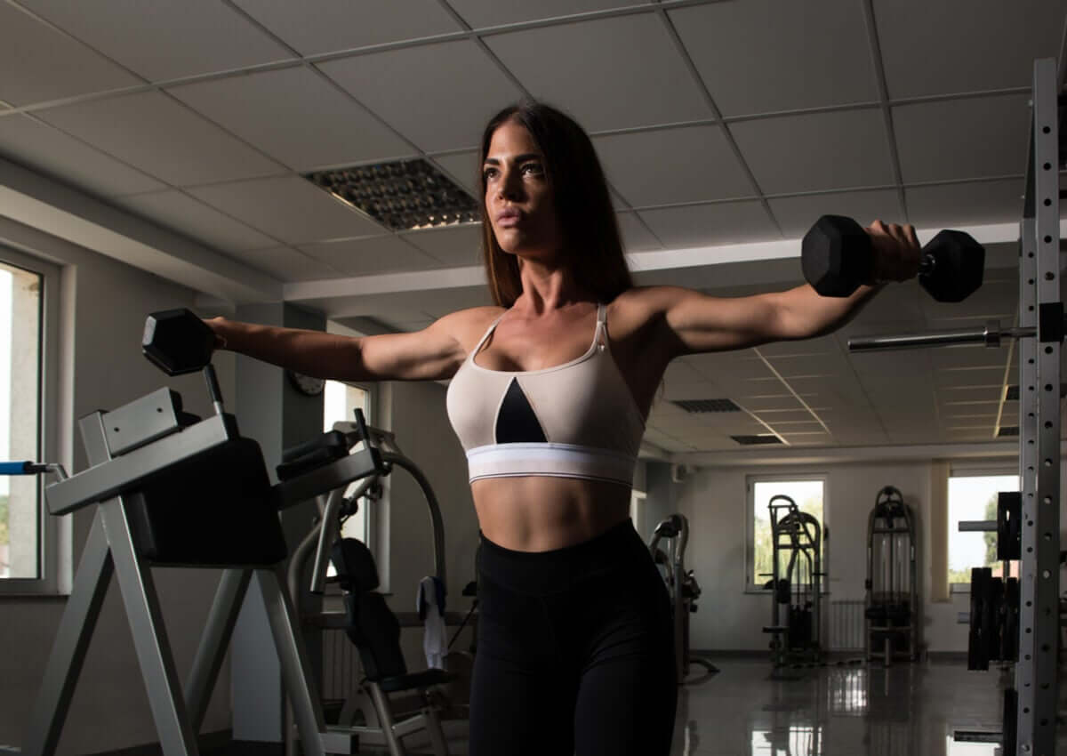 A woman doing lateral raises.