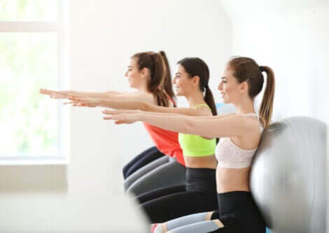 A group of women doing squats.