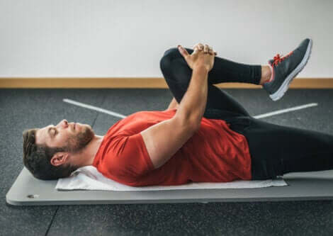 A man doing hip and glute stretches.
