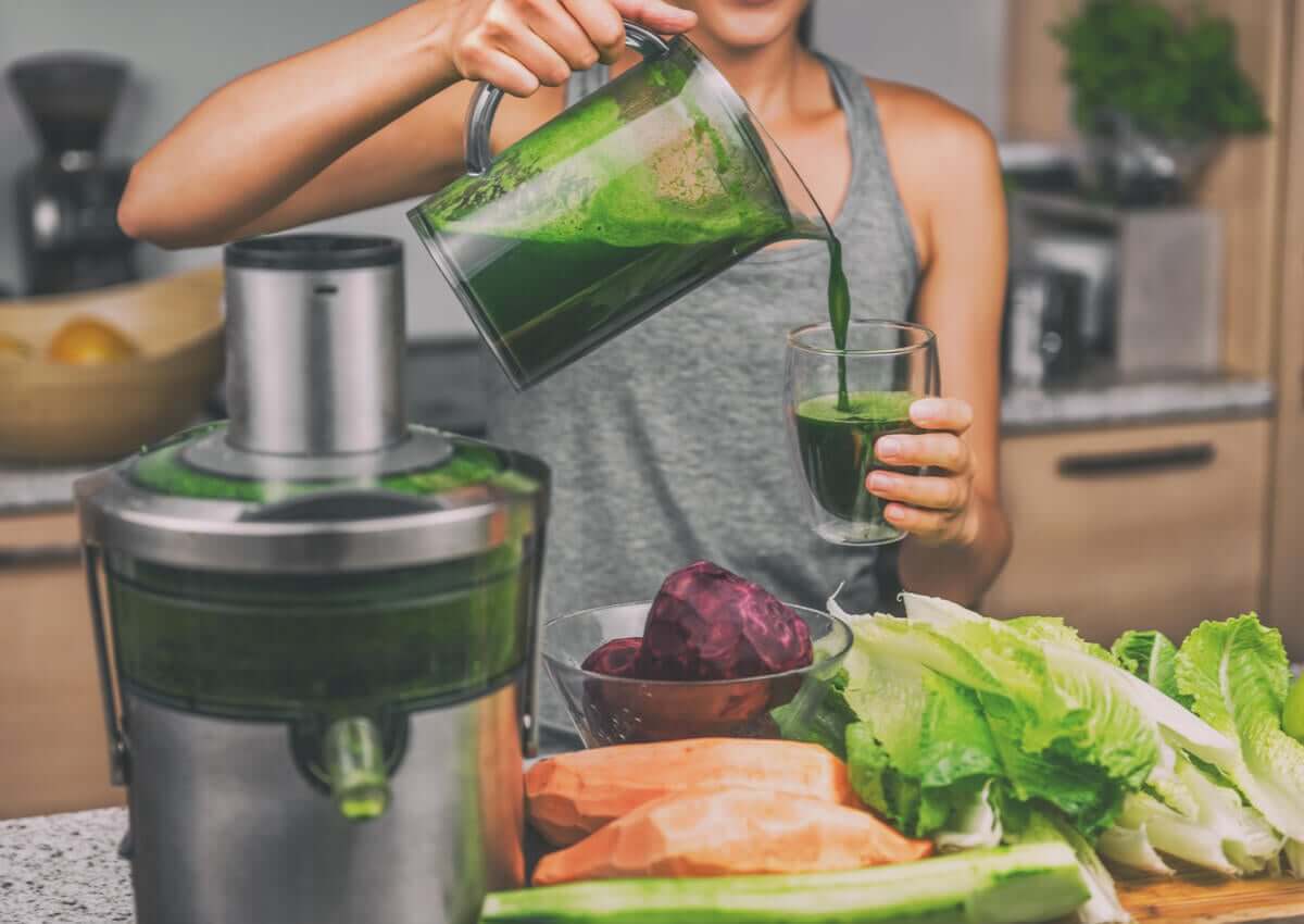A woman making vegetable juice.