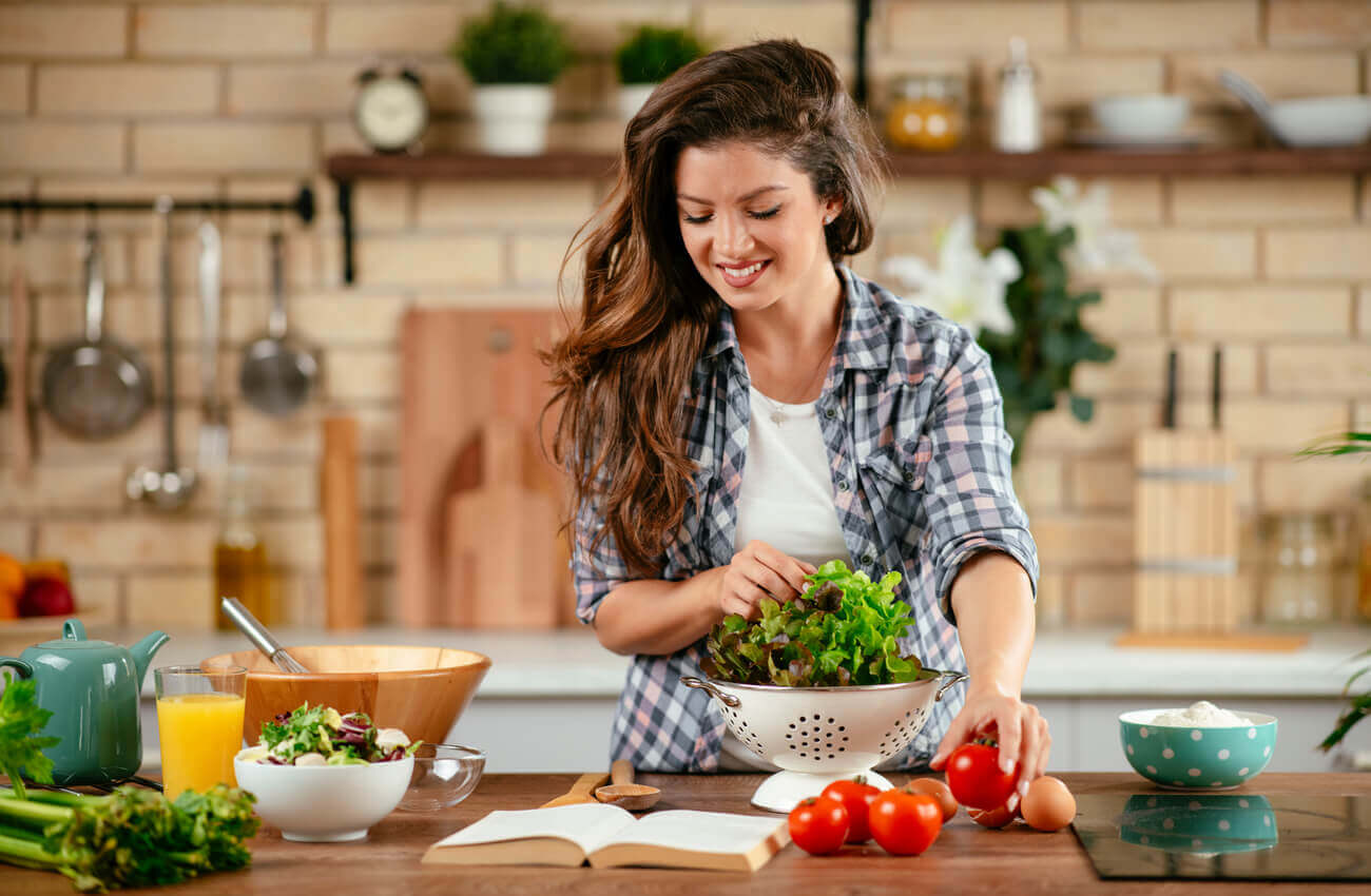 A woman making a salad.